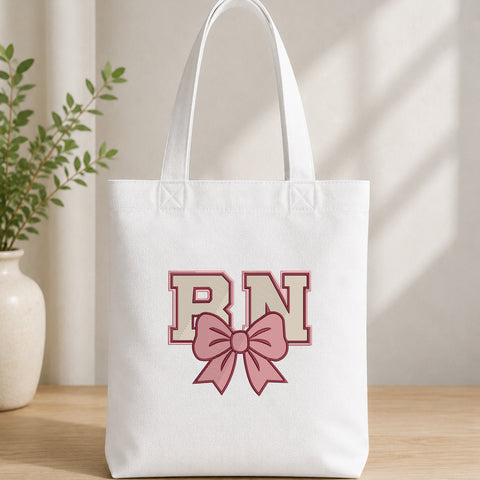 EF645. RN Coquette Pink Bow - White_Totebag.jpg