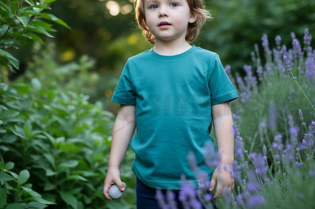 Kids' teal t-shirt in a garden setting Mock Up Photo Designangry 
