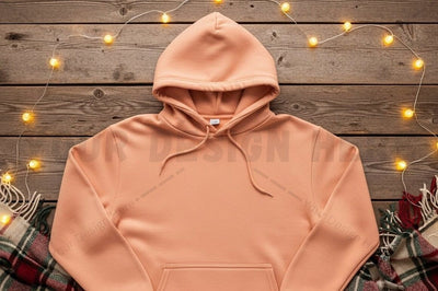 Peach hoodie on rustic wooden background Mock Up Photo Designangry 