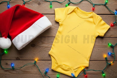Yellow baby onesie with santa hat and christmas lights Mock Up Photo Designangry 