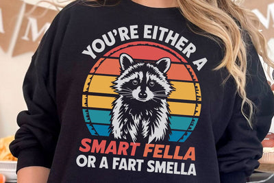 You're Either Smart Fella Or Fart Smella Meme Funny Raccoon T-Shirt SVG DesignDestine 